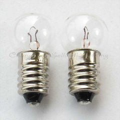 Two small instruments bulb screw E10 lamp holders with clear glass bulbs and metal bases.