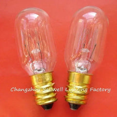 Two 220V 15W E14 miniature light bulbs with clear glass and gold bases on red background