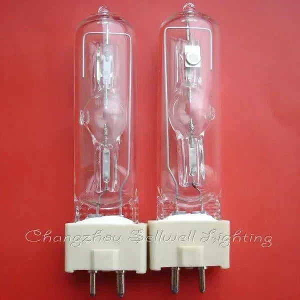 Pair of MSD 250W2 250W 90V stage light lamp bulbs with GY9.5 base on red background