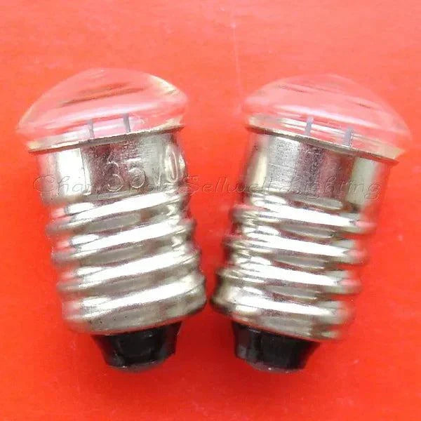 Miniature 1.35V 0.3A E10 base bulbs on orange background