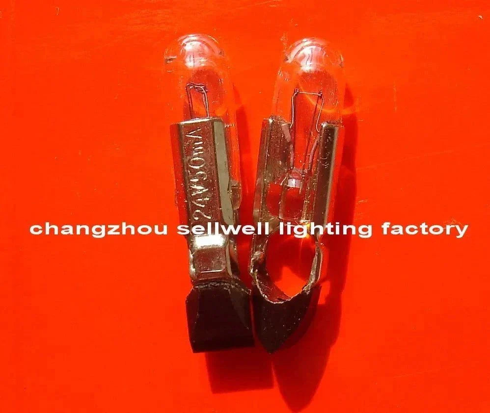 10pcs Telephone Bulb 24V 50MA BEE T5.5KX22 A936 with clear glass and metal base on orange background