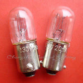 Close-up of two clear Ba9s lamp holders with 130V 20mA markings on red background
