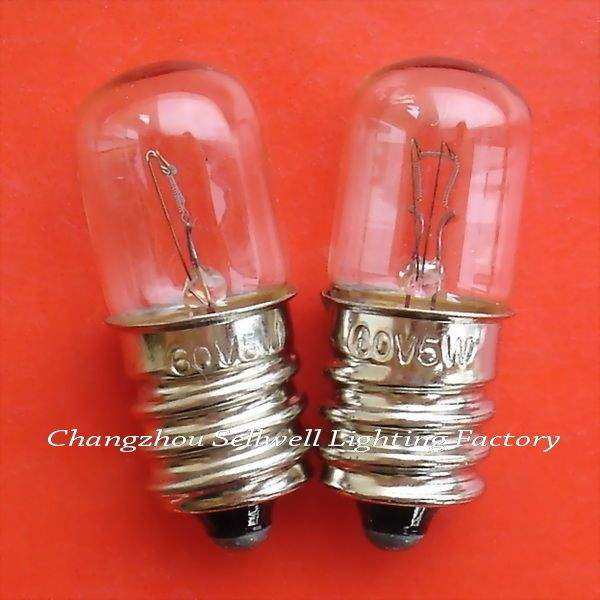 Two E12 instrument bulbs with clear glass and metallic screw bases on red background