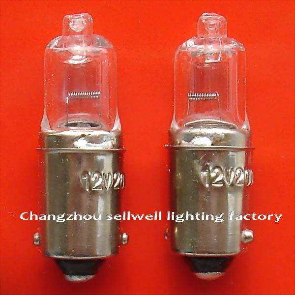 two 12v lamp holders Ba9s with clear glass bulbs on red background