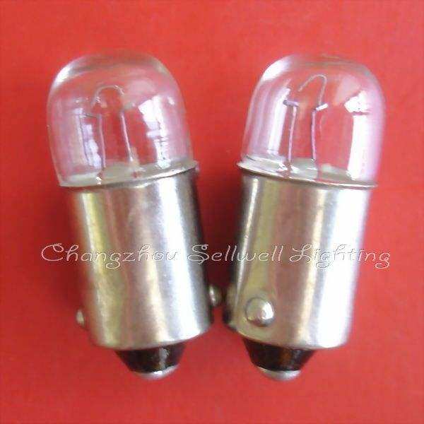 Two Ba9s lamp holders with clear glass bulbs on red background for educational use
