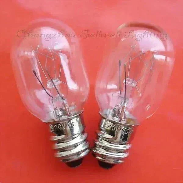 Two clear glass miniature lamps 220v 15w e12 bulbs on red background