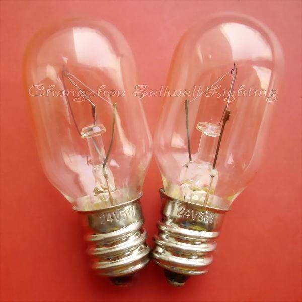 Two clear E12 instrument bulbs with metal screw bases on a red background